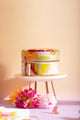 Spring Sweets Jewellery box - Front view of the round travel case on a display stand.