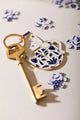 Cat in a mug Keychain - Perspective shot showing the golden metal edges and enamel finish.
