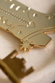 Cowboy Boot Keychain - Macro shot focusing on the golden spur detail of the cowboy boot.