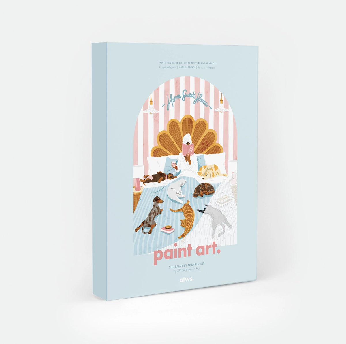 Life Without Humans paint by numbers kit box by All The Ways To Say, illustration of a person reading in bed surrounded by four dogs and three cats, "Home Sweet Home" text arched over a scalloped headboard, "paint art. The Paint By Number Kit by All The Ways To Say"