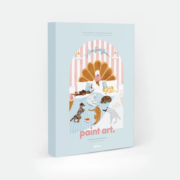 Life Without Humans paint by numbers kit box by All The Ways To Say, illustration of a person reading in bed surrounded by four dogs and three cats, "Home Sweet Home" text arched over a scalloped headboard, "paint art. The Paint By Number Kit by All The Ways To Say"