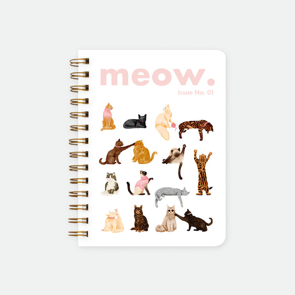 Meow. A5 spiral notebook by All The Ways To Say, white cover styled like a magazine with "meow. Issue No. 01" text and a grid of illustrated cats in various poses, spiral binding visible on the left edge