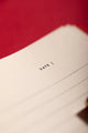 Bisou Bella Hardcover Notebook A5 - Macro shot of the clean lined interior pages and date section.