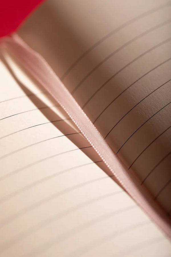 Bisou Bella Hardcover Notebook A5 - Close-up of the pink satin ribbon bookmark and paper texture.