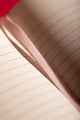 Bisou Bella Hardcover Notebook A5 - Close-up of the pink satin ribbon bookmark and paper texture.
