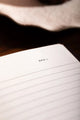 How to be fulfilled Hardcover Notebook A5 - Macro shot of the "DATE" header and premium lined paper.