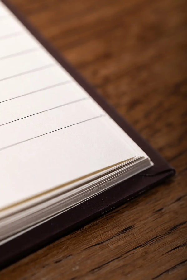How to be fulfilled Hardcover Notebook A5 - Macro view of the thick natural white paper edges.