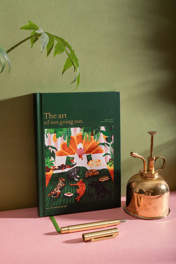 The art of not going out Hardcover Notebook A5 - Angled view of the green cover and cozy illustration.