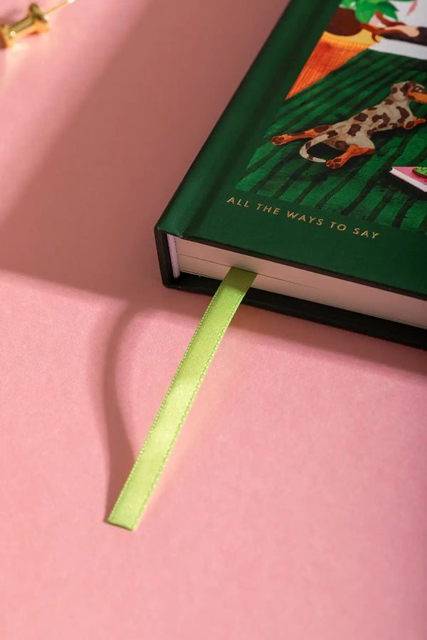 The art of not going out Hardcover Notebook A5 - Focus on the bright green satin ribbon bookmark.