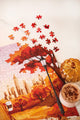 October Walks 1000 piece puzzle in progress, red autumn trees, a street lamp and the New York skyline, with a pumpkin jar and a latte