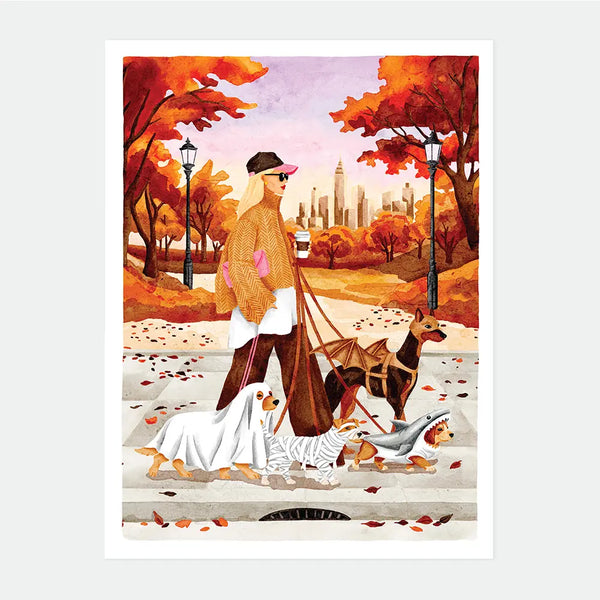 Illustrated poster of a woman walking four dogs dressed in Halloween costumes, a ghost, a mummy, a shark, and a bat, through an autumn park with a city skyline in the background, October Walks poster by All The Ways To Say