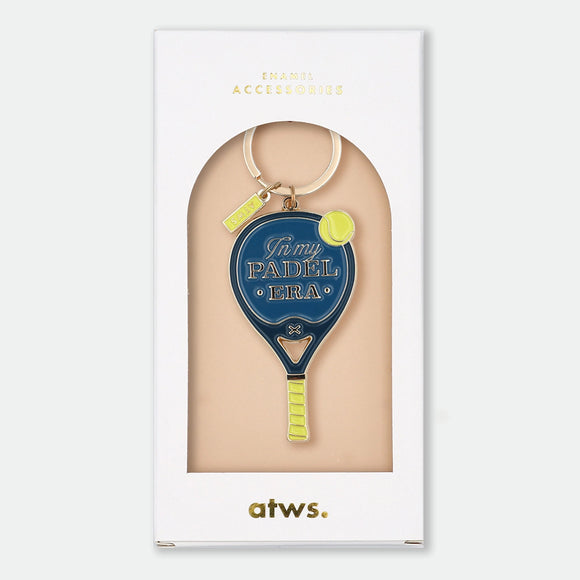 Enamel and metal keychain shaped like a navy blue padel racket with a yellow tennis ball, text reading "In my padel era," gold-tone ring and "ATWS" charm