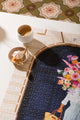 Parisian Door - Puzzle 1000 pieces: lifestyle shot of the puzzle with a cup of coffee and a small pink meringue.