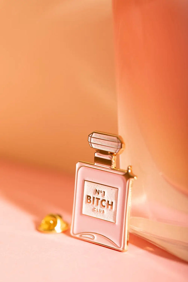 N°1 Bitch - Pins: macro shot showing the glittery texture and high-quality gold plating on the pin.
