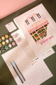 Pink Bakery paint by numbers kit with box, numbered canvas, 15 paint pots, two brushes, color chart and instructions