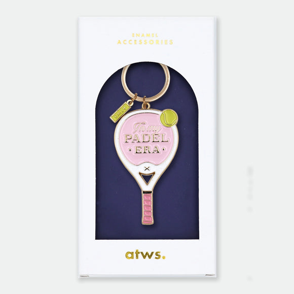 Enamel and metal keychain shaped like a pink and white padel racket with a yellow tennis ball, text reading "In my padel era," gold-tone ring and "ATWS" charm