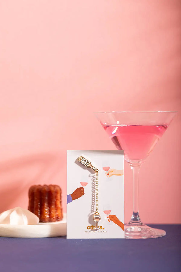 Duo Rose All Day Chain - Pins: the enamel bottle and glass pin set on its illustrated display card.