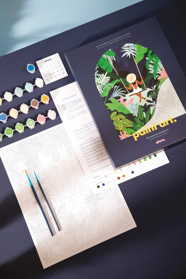 Swing paint by numbers kit with navy box, woman on a swing in a tropical jungle, canvas, paint pots and brushes