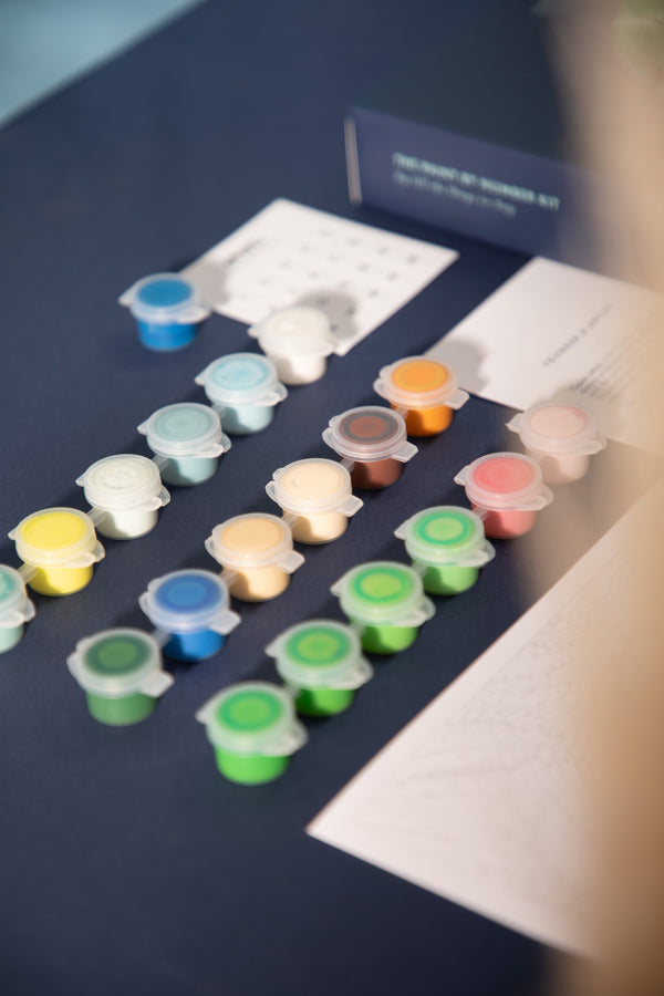 Numbered acrylic paint pots in greens, blues and warm tones from the Swing paint by numbers kit