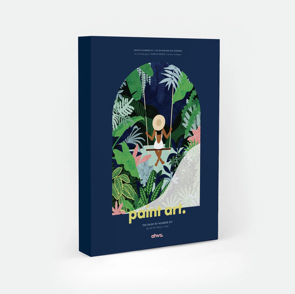 Swing paint by numbers kit box by All The Ways To Say, illustration of a woman in a straw hat seen from behind on a swing surrounded by dense tropical jungle foliage in an arched frame, "paint art. The Paint By Number Kit by All The Ways To Say"