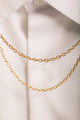 Duo Tiger Chain - Pins: macro shot of the double-layered gold link chain connecting the tiger pins.