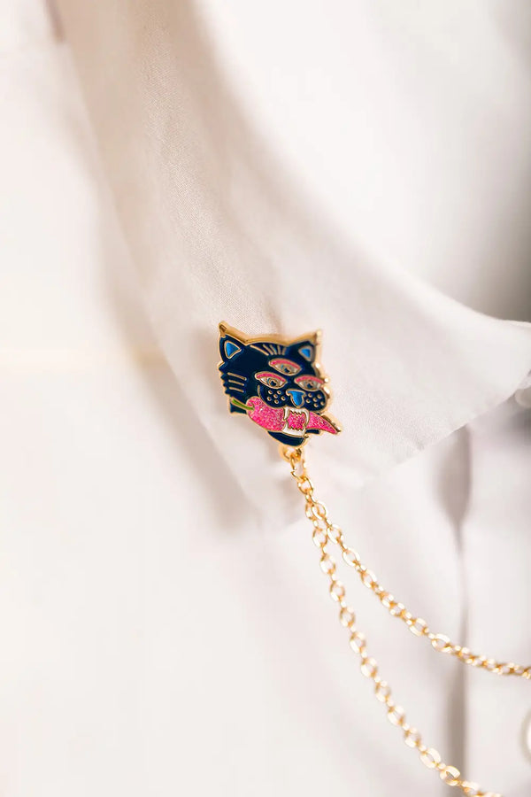 Duo Tiger Chain - Pins: close-up of the right tiger head pin showing the gold chain attachment and blue enamel.
