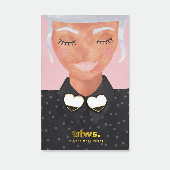 Set of two matching white and gold enamel pins shaped like hearts, each split cleanly in half, designed to be worn on either side of a shirt collar